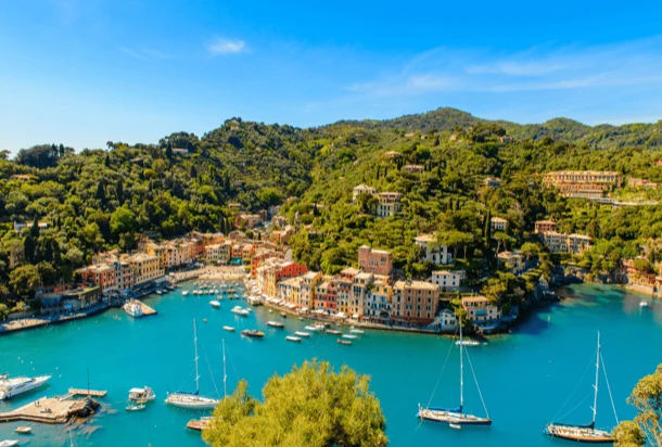 A stunning blue sky over the port of a European city, with clear blue water below.