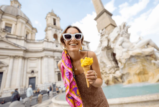 Tourist holding an ice cream in front of Trevi fountain